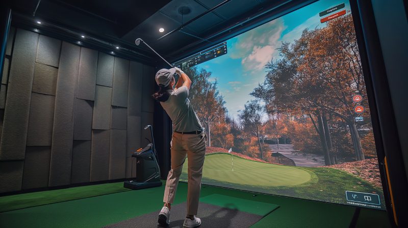 Golfer playing golf in indoor simulator Mixed media. golf simulator
